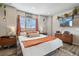 Cozy bedroom featuring a queen-sized bed, wood floors, and bright natural light at 10105 Morrison Rd, Lakewood, CO 80227