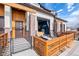 Beautiful exterior with a private front patio, brick accents, and a garage door window at 10105 Morrison Rd, Lakewood, CO 80227