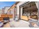 Outdoor patio connected to an open-concept living space with ample seating at 10105 Morrison Rd, Lakewood, CO 80227