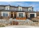 Exterior view of townhomes with solar panels, garage door windows, and modern design at 10105 Morrison Rd, Lakewood, CO 80227