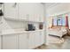 Hallway featuring white cabinets, countertops and a glimpse into the main bedroom at 10105 Morrison Rd, Lakewood, CO 80227