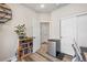 Home office with shelves, storage cabinets, a mini fridge, and wood flooring at 10105 Morrison Rd, Lakewood, CO 80227
