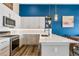 Modern kitchen with stainless steel appliances, white cabinetry, and a sleek breakfast bar at 10105 Morrison Rd, Lakewood, CO 80227
