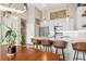 Open-concept kitchen with modern island, stylish bar seating and access to living area at 10105 Morrison Rd, Lakewood, CO 80227