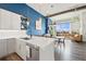 Bright kitchen with white countertops, stainless steel appliances, and an open view into the living area at 10105 Morrison Rd, Lakewood, CO 80227