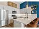 Bright, modern kitchen with stainless steel appliances, white countertops and cabinets at 10105 Morrison Rd, Lakewood, CO 80227