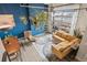 Bright living room features a fireplace, large windows, and a comfortable yellow couch at 10105 Morrison Rd, Lakewood, CO 80227