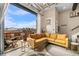 Open living room with large windows and modern decor leading to an outdoor patio at 10105 Morrison Rd, Lakewood, CO 80227