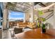 Bright living room with expansive glass door to balcony and comfortable yellow couch at 10105 Morrison Rd, Lakewood, CO 80227