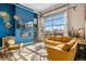 Stylish living room with modern decor, a cozy fireplace, and large garage door windows at 10105 Morrison Rd, Lakewood, CO 80227