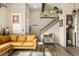 Comfortable living room with a yellow sofa, cozy decor, and natural light at 10105 Morrison Rd, Lakewood, CO 80227