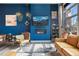 Chic living room featuring blue accent wall, a cozy fireplace, and open access to the outdoors at 10105 Morrison Rd, Lakewood, CO 80227