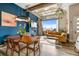 Open concept living space with glass door to balcony, fireplace, dining area and a bright blue accent wall at 10105 Morrison Rd, Lakewood, CO 80227