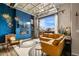 Inviting living room with a fireplace, TV, modern decor, and a bright atmosphere from the expansive window at 10105 Morrison Rd, Lakewood, CO 80227