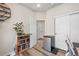 Cozy home office featuring hardwood floors, mini fridge, and stylish white doors, perfect for remote work at 10105 Morrison Rd, Lakewood, CO 80227