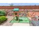 Backyard features a wooden playset, artificial turf, rock landscaping, and a wooden fence at 155 Xenon St # 33, Denver, CO 80228