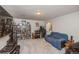 Entertainment room with a blue couch, dark furniture, carpeting, and shelving at 155 Xenon St # 33, Denver, CO 80228