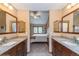 Bright bathroom featuring granite countertops, dual vanities, and an open view of the main bedroom at 155 Xenon St # 33, Denver, CO 80228