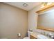 Half bathroom with a vanity, toilet, and a mirror at 155 Xenon St # 33, Denver, CO 80228