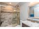 Updated bathroom featuring a stylish glass shower, modern vanity, and a decorative mirror at 155 Xenon St # 33, Denver, CO 80228