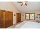Bedroom features carpet flooring, a ceiling fan, neutral paint, and two large closets at 155 Xenon St # 33, Denver, CO 80228