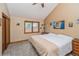 Bedroom features carpet flooring, a ceiling fan, neutral paint, and a large window with natural light at 155 Xenon St # 33, Denver, CO 80228