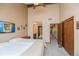 Bedroom features carpet flooring, a ceiling fan, high ceilings, ensuite bathroom, and two closets at 155 Xenon St # 33, Denver, CO 80228