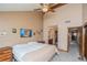 Bedroom features carpet flooring, a ceiling fan, high ceilings, and an ensuite bathroom at 155 Xenon St # 33, Denver, CO 80228