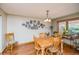 Bright dining room features hardwood floors, a wooden table with seating, and natural lighting at 155 Xenon St # 33, Denver, CO 80228