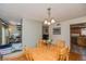 Bright dining room features hardwood floors, a wooden table with seating, and decorative lighting fixture at 155 Xenon St # 33, Denver, CO 80228