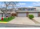 Charming townhome featuring a two-car garage and well-maintained landscaping at 155 Xenon St # 33, Denver, CO 80228
