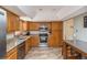 Kitchen featuring stainless steel appliances, granite countertops and wood cabinetry at 155 Xenon St # 33, Denver, CO 80228