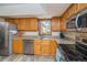 Modern kitchen with stainless steel appliances, granite countertops, and oak cabinets at 155 Xenon St # 33, Denver, CO 80228