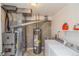 Functional laundry room with washer, dryer, and utilities including a water heater at 155 Xenon St # 33, Denver, CO 80228