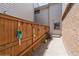 View of a well-maintained side yard with a wooden fence and decorative hanging plants at 155 Xenon St # 33, Denver, CO 80228