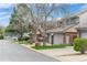 Neighborhood street showcasing well-kept townhomes and landscaping with a tennis court in the background at 155 Xenon St # 33, Denver, CO 80228