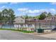 Community tennis courts and a fenced pool area with lounge chairs for resident enjoyment at 155 Xenon St # 33, Denver, CO 80228