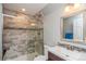 Renovated bathroom with a tiled shower, glass door, and modern fixtures at 155 Xenon St # 33, Lakewood, CO 80228