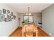 Classic dining room boasting hardwood floors, a hanging chandelier, and decorative pictures at 155 Xenon St # 33, Lakewood, CO 80228