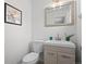 Well-lit half bathroom features modern vanity and neutral color scheme at 1195 S Kendall St, Lakewood, CO 80232