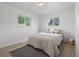 A bedroom with carpet, two windows, and neutral décor at 1195 S Kendall St, Lakewood, CO 80232