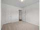 Bedroom featuring neutral paint, carpet, a closet, and a connecting door at 1195 S Kendall St, Lakewood, CO 80232