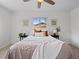 Bright bedroom with ceiling fan, comfortable bed, and natural light from the window at 1195 S Kendall St, Lakewood, CO 80232