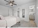Inviting bedroom featuring a ceiling fan, plush carpet, and convenient access to a private bathroom at 1195 S Kendall St, Lakewood, CO 80232