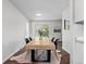 Bright dining room features modern table with seating for six and sliding glass doors to the backyard at 1195 S Kendall St, Lakewood, CO 80232