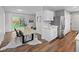 Bright dining area featuring a modern table, stylish seating, and convenient access to the backyard at 1195 S Kendall St, Lakewood, CO 80232