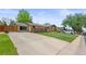 Charming home with a well-manicured lawn, spacious driveway, and inviting curb appeal at 1195 S Kendall St, Lakewood, CO 80232