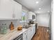 Beautiful kitchen featuring stainless steel appliances, granite countertops, white cabinets, and wood floors at 1195 S Kendall St, Lakewood, CO 80232