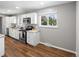 Updated kitchen featuring stainless steel appliances, sleek countertops, and stylish flooring at 1195 S Kendall St, Lakewood, CO 80232