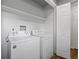 A laundry room with appliances and storage shelves at 1195 S Kendall St, Lakewood, CO 80232